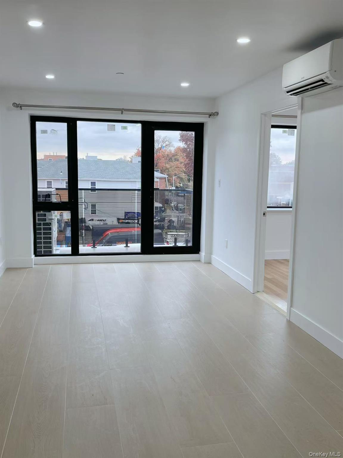 Spare room featuring recessed lighting and an AC wall unit