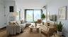 Living room with a wall of windows, wood finished floors, and a wall mounted AC