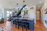 Kitchen with crown molding, pendant light fixtures, and recessed lighting