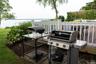 View of patio / terrace featuring grilling area and a deck with water view