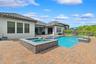 The backyard is the focal point of this property.  Oversized patio with a heated salt pool and built-in spa.