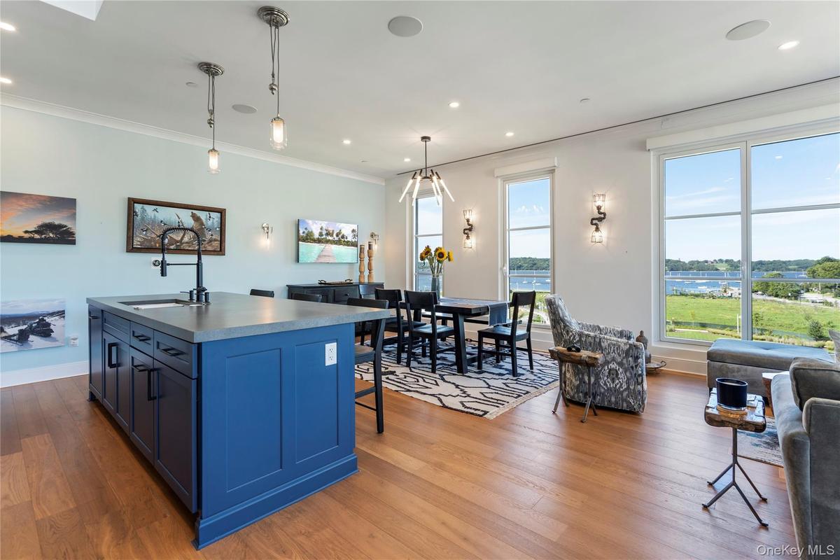 Kitchen featuring blue cabinetry, hanging light fixtures, and a kitchen island