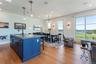 Kitchen featuring blue cabinetry, hanging light fixtures, and a kitchen island