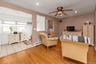 Office area with light wood-style flooring, a baseboard heating unit, ceiling fan, recessed lighting, and a wall mounted AC