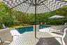 Outdoor pool featuring a deck and outdoor dining area