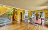 Entering formal living room from center hall,  featuring terra cotta tile princess staircase,  floor to ceiling fireplace, 9.5 ft ceilings, solid wood