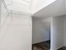 Walk in closet downstairs bedroom, under stairs storate