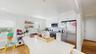 Kitchen featuring light wood-style flooring, white cabinetry, a kitchen island, a sink, and stainless steel appliances