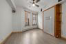 Unfurnished room featuring baseboard heating, light wood-style floors, and ceiling fan