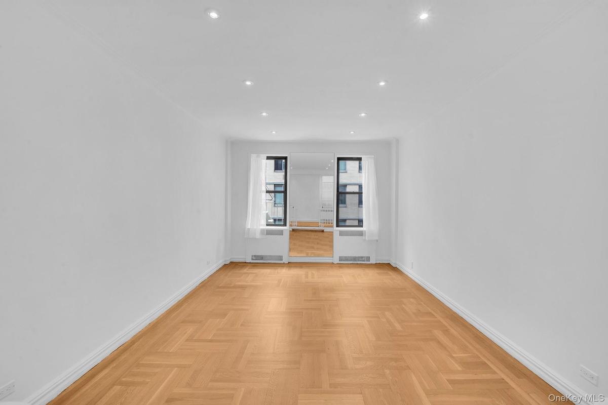 Sunken living room featuring hardwood floors