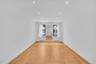 Sunken living room featuring hardwood floors