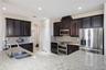 Kitchen features granite counters and timeless espresso cabinets