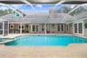 Pool/Spa view showcasing wrap around Hacienda floor plan with French doors.