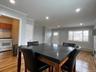 Dining space with a baseboard heating unit, light wood-type flooring, ornamental molding, and recessed lighting