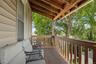 Covered balcony featuring wood railing and exposed wood beams