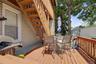 Wood-finish deck with a wood railing and exterior staircase