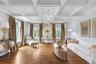 Coffered ceiling with a crystal chandelier, wood-finish flooring, and multiple windows