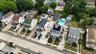 Aerial perspective of a residential neighborhood featuring multiple detached homes with varying architectural styles