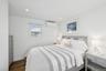 Bedroom featuring dark wood finished floors, an AC wall unit, and recessed lighting