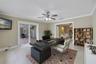 A VERSATILE BONUS SPACE is ideal as a media room, game room, or second living area, with sliding glass doors opening to the patio and pool for seamles