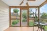 Screened porch featuring a paneled ceiling, wood-finish framing, and a ceiling fan