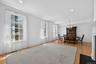 To the left of the entrance you will find the open living and dining area. Large windows fill the room with natural light, creating a spacious setting