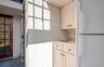 Kitchen with freestanding refrigerator, a wealth of natural light, dark tile patterned flooring, light countertops, and a sink