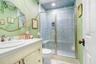 Fun upstairs full bathroom with floor to ceiling mosaic tiled shower which includes seat and shampoo nook.