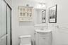Bathroom featuring vanity and a shower stall