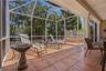 RELAX AND ENJOY THE SUNSHINE. VINYL FENCING ENCIRCLES THE BEAUTIFUL MANICURED LANDSCAPING FEATURING MANY MATURE PALMS.