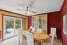 Dining space featuring light tile patterned floors, crown molding, and a ceiling fan