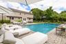Swimming pool featuring an outdoor hangout area, a patio area, and view of wooded area