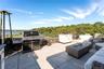 View of rooftop terrace with an outdoor kitchen and a water view