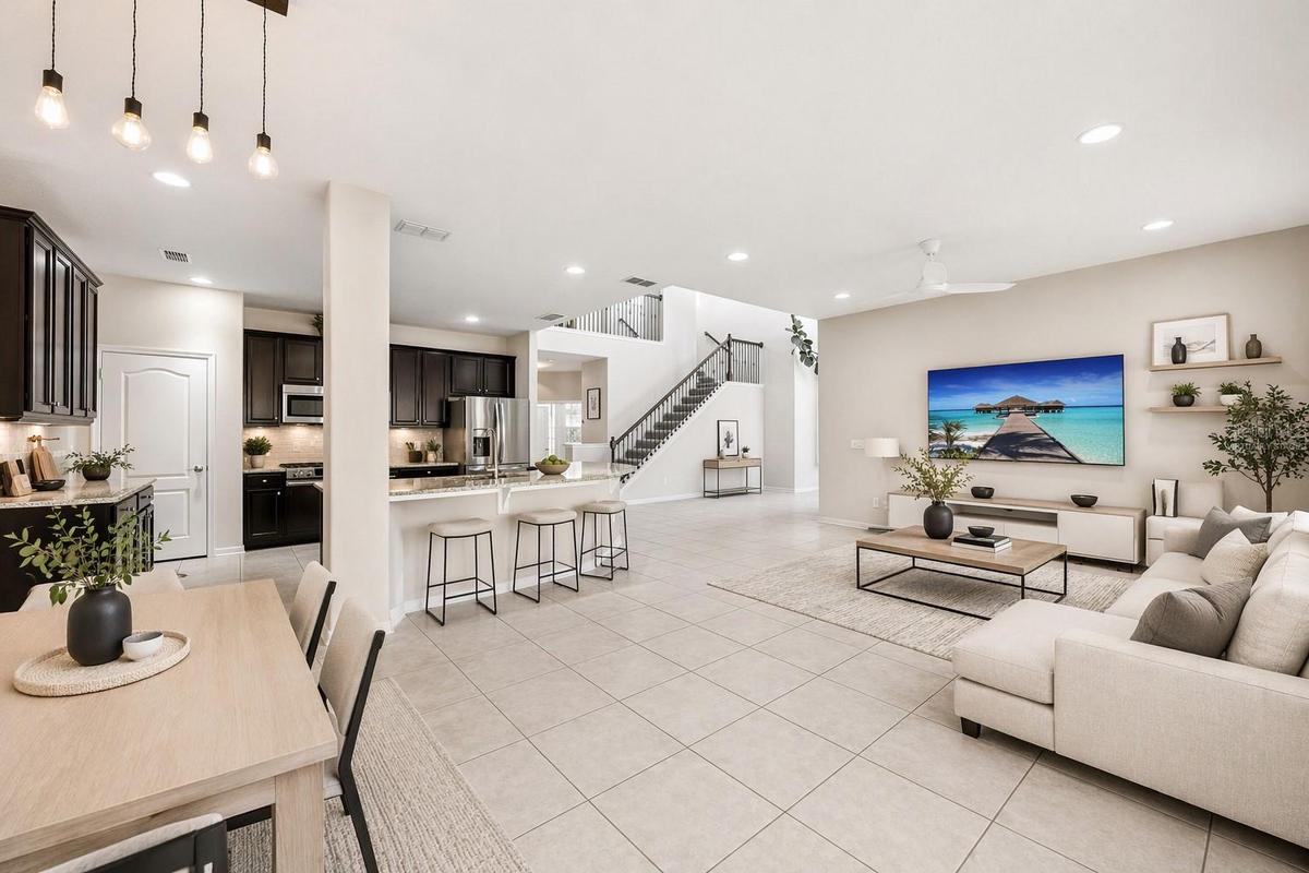 Virtually staged great room open to the kitchen