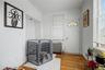 Hardwood flooring throughout, multiple windows, and crown molding