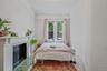 Bedroom with a fireplace and wood finished floors