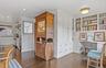 Office featuring a sink, built in study area, dark wood-style floors, and baseboards