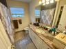 Bathroom featuring tile patterned flooring, vanity, and toilet