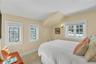 Maids quarters bedroom featuring lofted ceiling