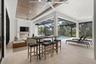 The covered lanai has wood ceilings and oversized ceiling fans.