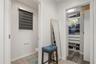 Spacious walk-in closet with custom built-in shelving and drawer storage for optimal organization.