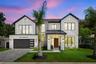 The roof combines architectural shingles with standing-seam metal accents