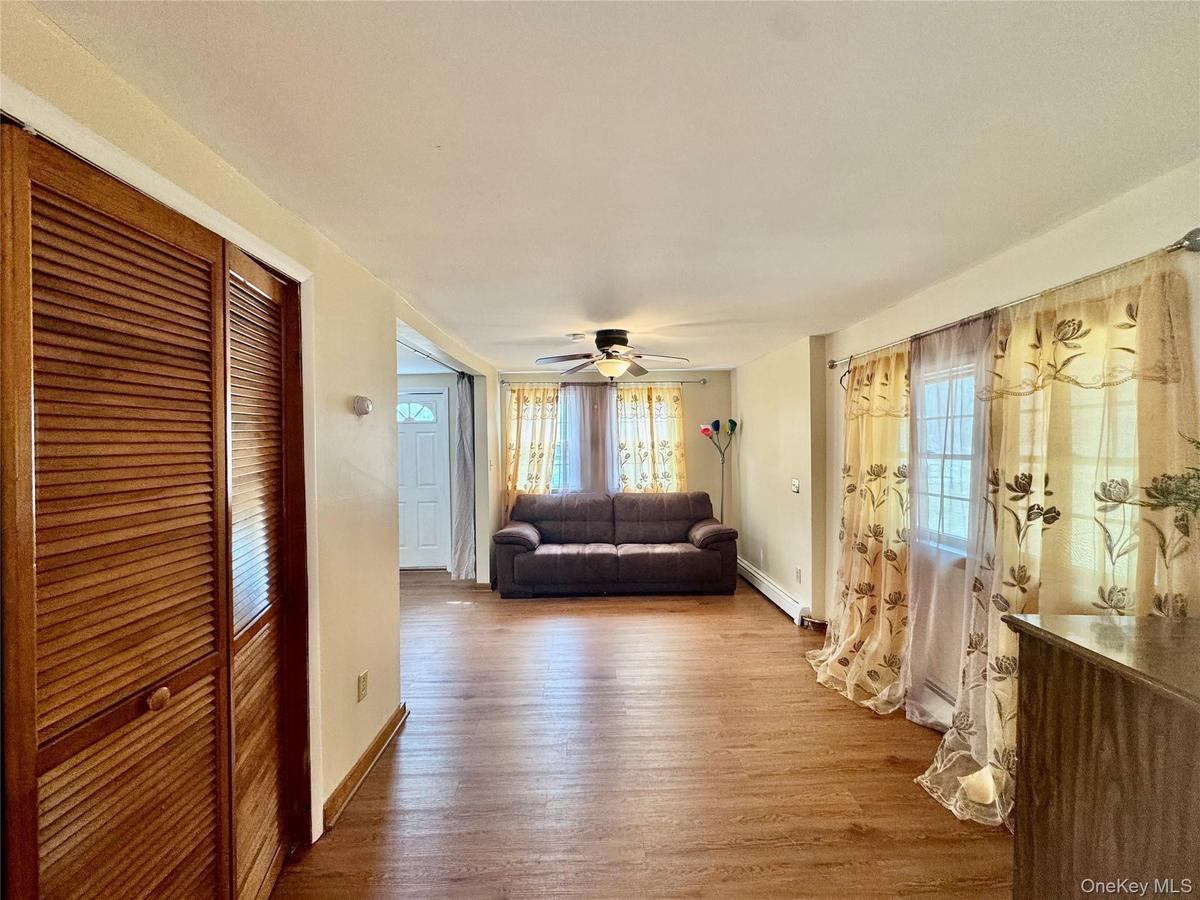 1- Unfurnished living room with baseboards, ceiling fan, and wood finished floors