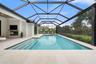 The resort-style saltwater pool and spa feature elegant water elements, an alarm system, and both solar and gas heating systems allowing for year-roun