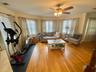 Living room featuring ceiling fan and light hardwood / wood-style floors