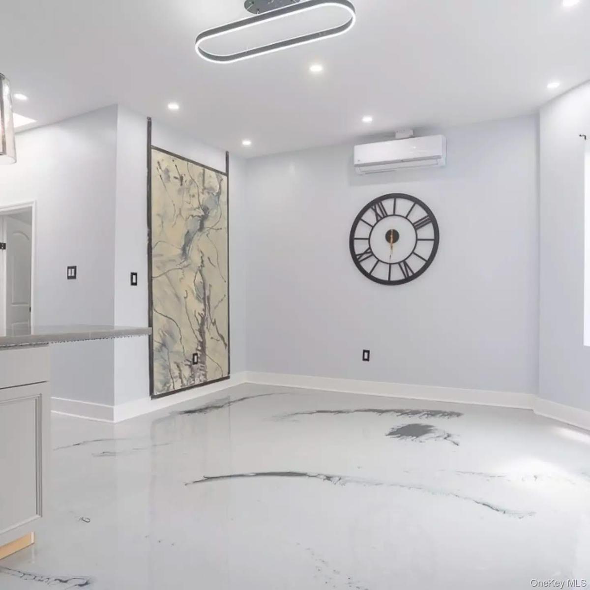 Empty room with recessed lighting, finished concrete floors, and a wall mounted AC
