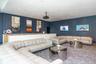 The private screening room features comfortable sofa seating, offering and ideal setting for movie nights, game-day gatherings, and special events.