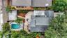 An overhead view shows the home’s layout, pool, deck, mature landscaping, and rear parking area.