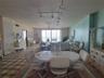 Living room and dining room areas with ocean view