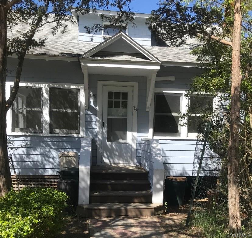 View of front of home featuring a shingled roof